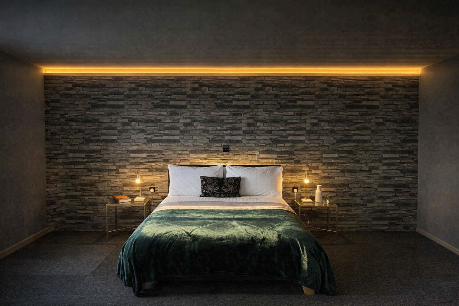 Bed inside The Coastal Suite with stone-clad wall
