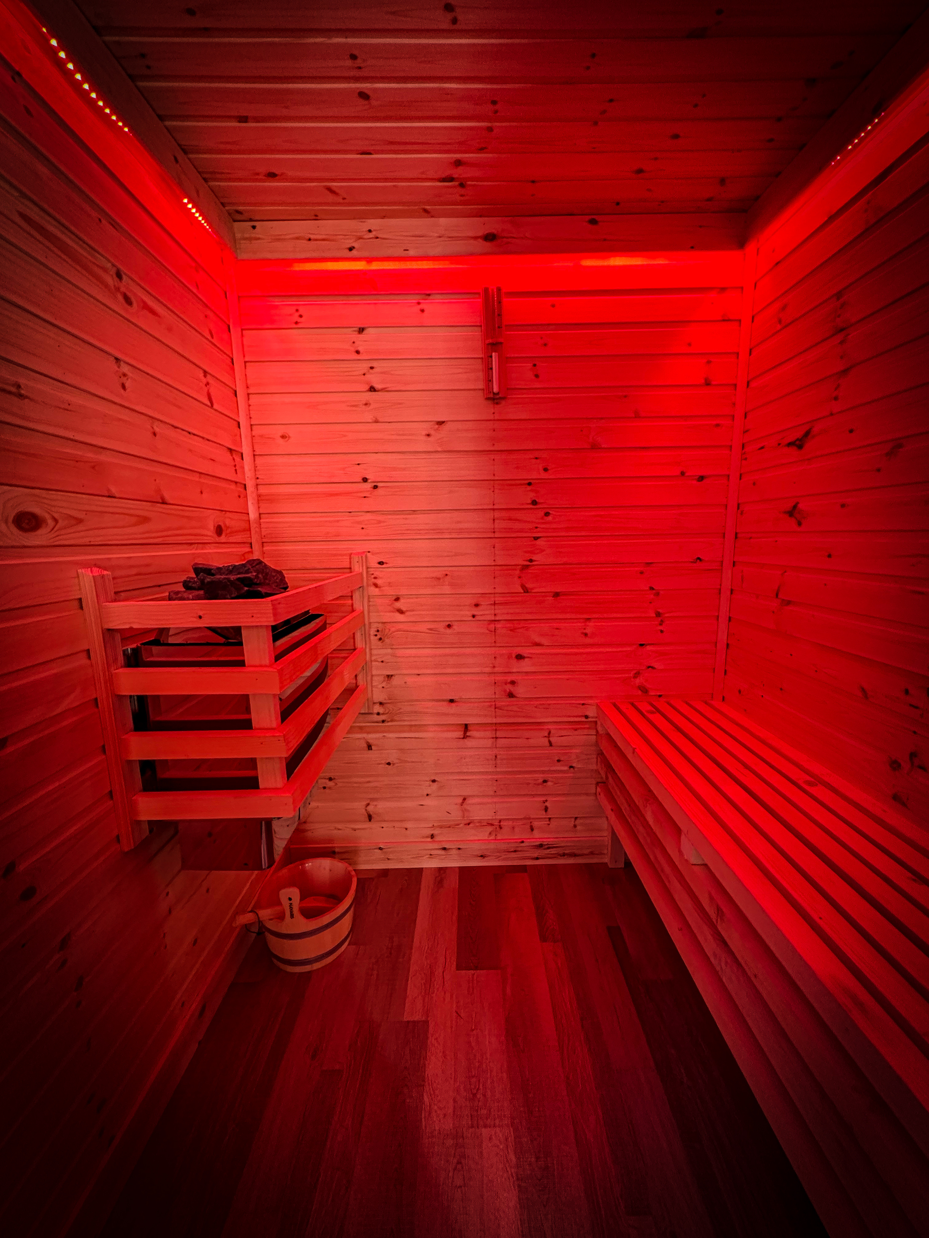 Cedar sauna interior lit warmly inside The Atlantic